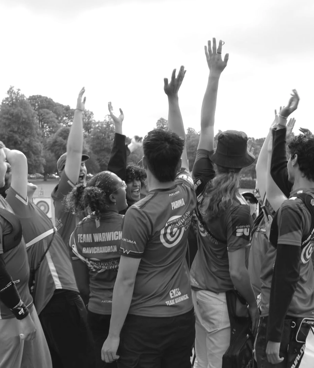 Warwick archers cheering together on an outdoor range